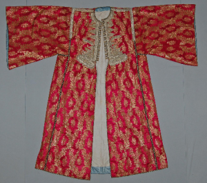 "Moroccan caftan in red silk with gold thread and black and gold braid"